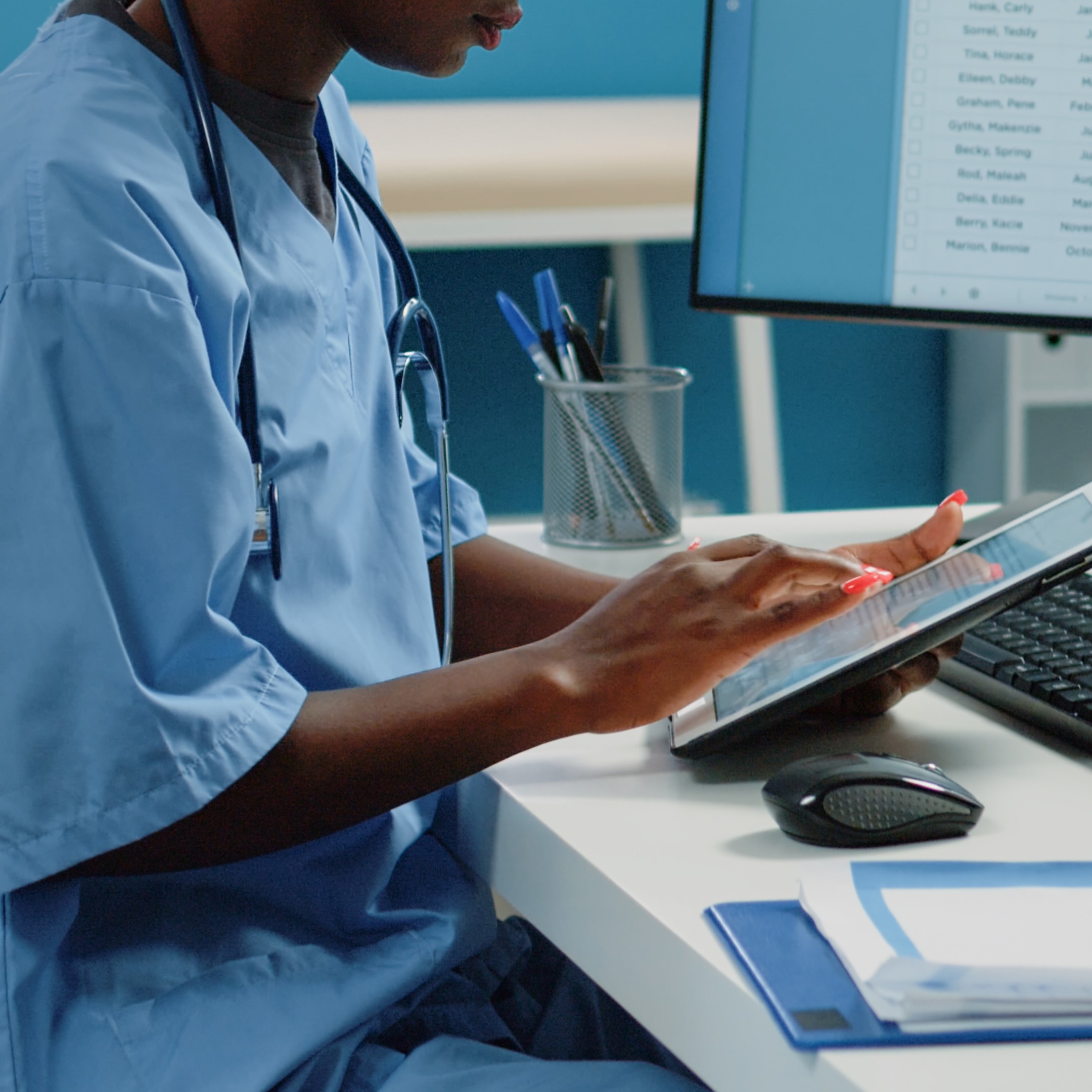 African american nurse using digital tablet for treatment